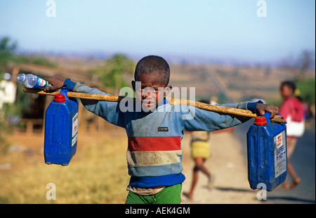 Child carrying water, Madagascar Stock Photo