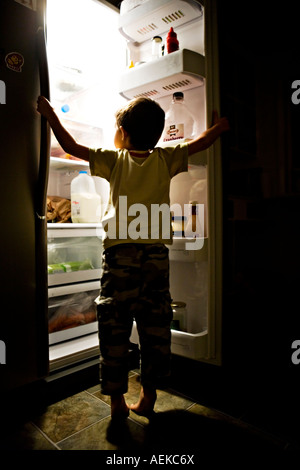 Child searches fridge Stock Photo