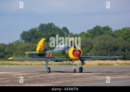 Soviet primary trainer aircraft Yakovlev Yak-52, G-YAKX landing at Dunsfold in Surrey UK 2007 Stock Photo