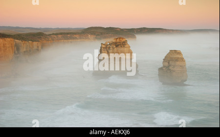 Two of the Twelve Apostles in mist at sunset near Port Campbell on the Great Ocean Road in Victoria Australia Stock Photo