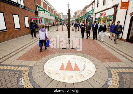 Shoppers walk around Lichfield town centre. Stock Photo