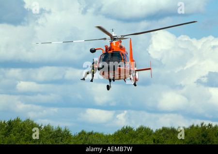 A US Coast Guard HH 65B SAR Helicopter demonstrates a search and rescue mission at Binghamton Airshow New York Stock Photo