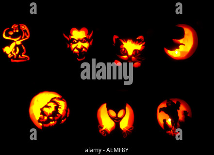 Freshly carved jack-o-lanterns at a family Halloween party in Utah, USA shine by candlelight in the dark. Stock Photo