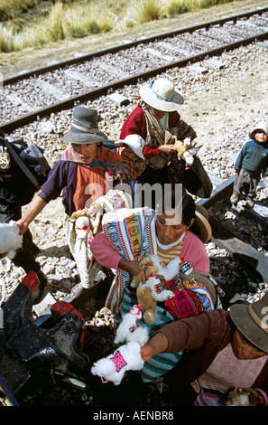 Women selling gifts on railway track, near La Raya, Puno to Cusco Perurail train journey, Peru Stock Photo