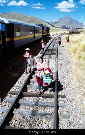Women selling gifts on railway track, near La Raya, Puno to Cusco Perurail train journey, Peru Stock Photo