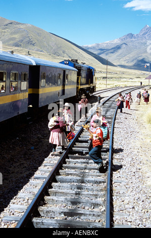 Women selling gifts on railway track, near La Raya, Puno to Cusco Perurail train journey, Peru Stock Photo