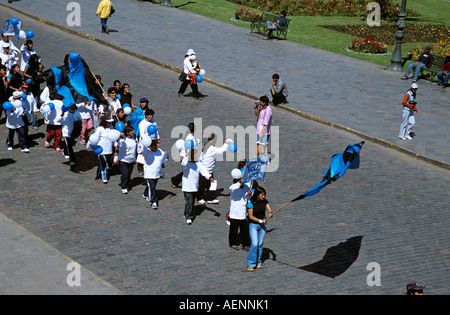 Sports team parading in Plaza de Armas, Cusco, Peru Stock Photo
