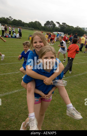 Two young girls at School sports day Ysgol Gymraeg welsh primary  school Aberystwyth Ceredigion Wales UK Stock Photo