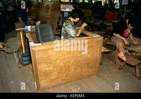 Wood carver working in furniture factory, near Bangkok, Thailand Stock Photo