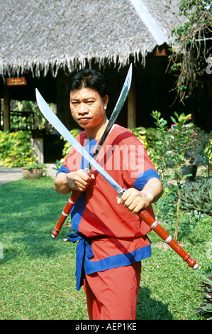 Martial arts performer holding swords, posing, Riverside Rose Garden, Sampran Nakorn Pathom, near Bangkok, Thailand Stock Photo