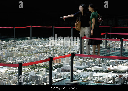 Two Chinese women looks at the model of Beijing s city master plan at Beijing Planning Exhibition Hall 29 Aug 2007 Stock Photo