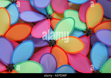 Close up on a mass of overlapping multi colored six vaned or petaled toy windmills laid out flat Stock Photo