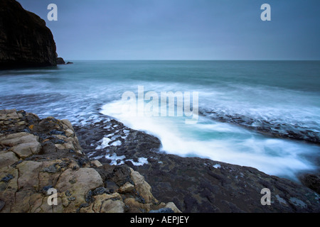 Waves surge into a large rock pool on Dancing Ledge, Purbeck, Dorset Stock Photo