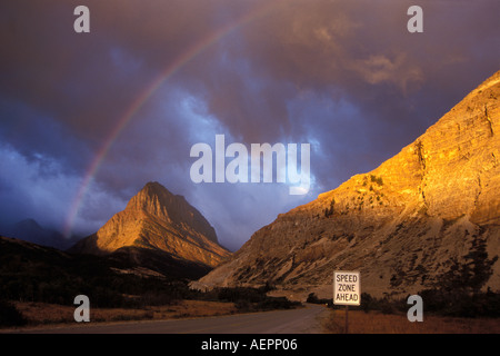 rainbow at sunrise along the Many Glacier Road with Mount Gould Glacier National Park Montana Stock Photo