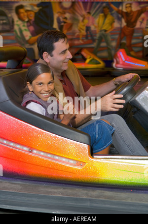 Father and daughter play dodgems at a fair in  "Milly la Foret", France Stock Photo