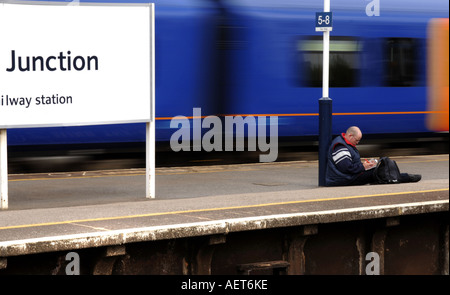 A man trainspotting at Clapham Junction train station in south west London, UK Stock Photo