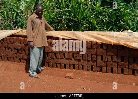 Man showing off bricks being sun dried in Western Kenya at the side of the Kisumu Maseno road in Kenya East Africa Stock Photo