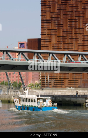 Boat on river Nervion passing under Puente Euskalduna Euskalduna Palace in background Bilbao Stock Photo