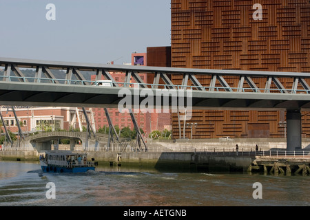 Boat on river Nervion passing under Puente Euskalduna Euskalduna Palace in background Bilbao, Basque Country Spain Stock Photo