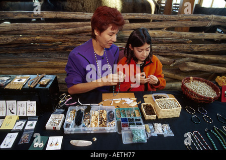 Saskatoon Canada,Wanuskewan Native Heritage Park Cree Nation,indigenous people mother parent girl daughter,selling beadwork making bracelets necklaces Stock Photo