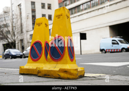 Police yellow no waiting cones on a London street Stock Photo