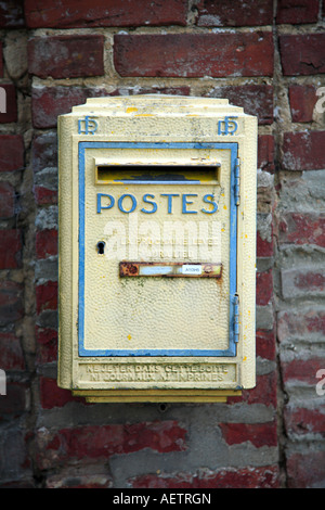 Yellow post box mounted on a wall, France. Stock Photo