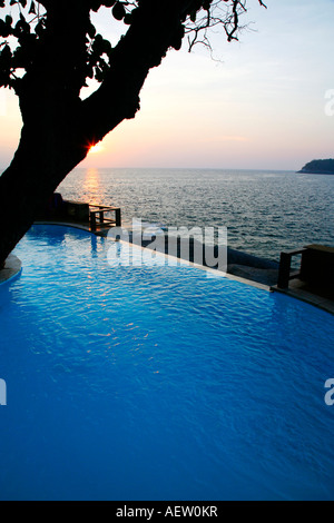 Sunset over swimming pool at resort, Kata Beach, Phuket Thailand Stock Photo