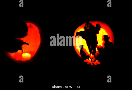 Freshly carved jack-o-lanterns at a family Halloween party in Utah, USA shine by candlelight in the dark. Stock Photo