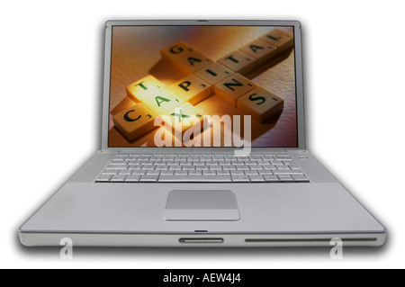 LAP TOP COMPUTER WITH SCRABBLE LETTERS ON SCREEN SPELLING WORDS CAPITAL GAINS TAX Stock Photo