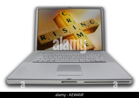 LAP TOP COMPUTER WITH SCRABBLE LETTERS ON SCREEN SPELLING WORDS RISING CRIME Stock Photo