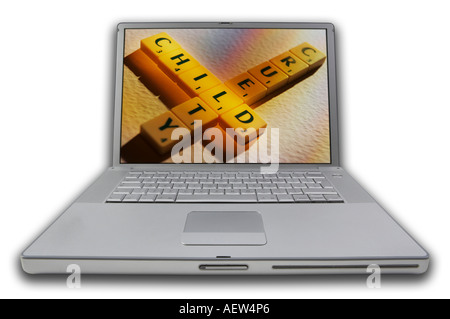 LAP TOP COMPUTER WITH SCRABBLE LETTERS ON SCREEN SPELLING WORDS CHILD CRUELTY Stock Photo