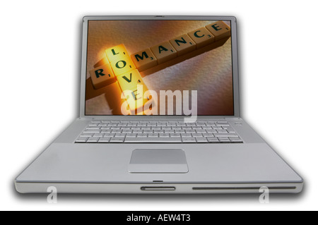 LAP TOP COMPUTER WITH SCRABBLE LETTERS ON SCREEN SPELLING WORDS LOVE ROMANCE Stock Photo