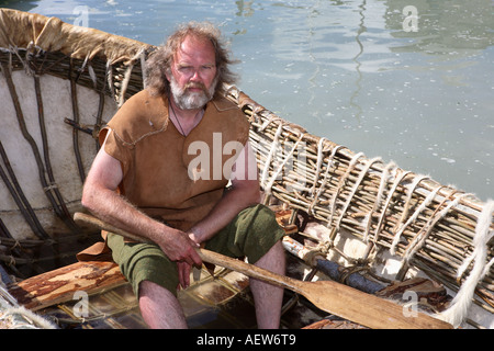 Neolithic animal skin coracle, wicker frame boat covered with skins. Small, rounded, lightweight  paddle boat at the Portsoy Boat Festival, Moray Stock Photo