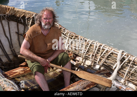 Neolithic animal skin coracle, wicker frame boat covered with skins. Small, rounded, lightweight  paddle boat at the Portsoy Boat Festival, Moray Stock Photo