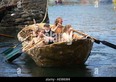 Neolithic animal skin coracle, wicker frame boat covered with skins. Small, rounded, lightweight  paddle boat at the Portsoy Boat Festival, Moray Stock Photo