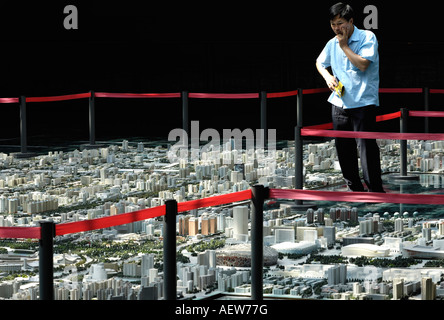 A Chinese man looks at the model of Beijing s city master plan at the Beijing Planning Exhibition Hall 29 Aug 2007 Stock Photo