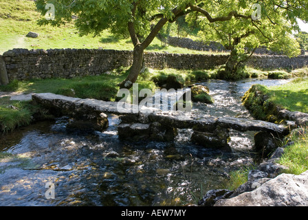 Clapper Bridge over Malham Beck in the Yorkshire Dales UK Stock Photo