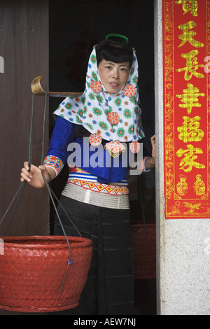 China, Fujian Province, Hui'an. A woman in her native dress holds