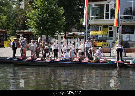 Tourists entering a typical wooden punt at the harbour of Luebbenau Spree Forest Spreewald Brandenburg Germany Stock Photo