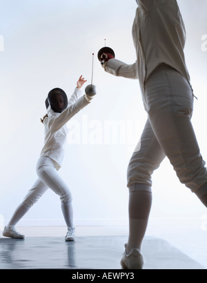 two people fencing Stock Photo