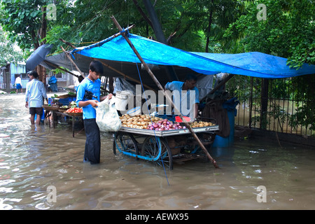 vegetable vendor hand cart standing in knee deep water after rainfall Bombay now Mumbai India Stock Photo