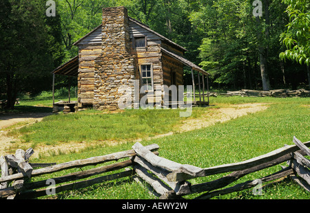 An ancient cabin belonging to the mountain people of Appalachia and s split rail fence in Cades Cove Great Smoky Mountains NP, Tennessee. Stock Photo