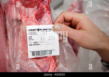 Food quality control Inspector checks in the frozen area in a butcher s shop in a supermarket Stock Photo