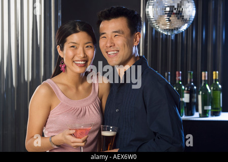 Couple having drinks in a bar Stock Photo