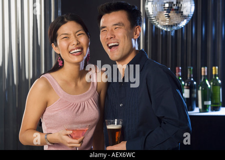 Couple having drinks in a bar Stock Photo
