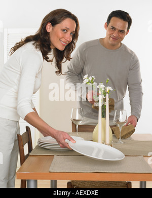 Couple setting the table Stock Photo
