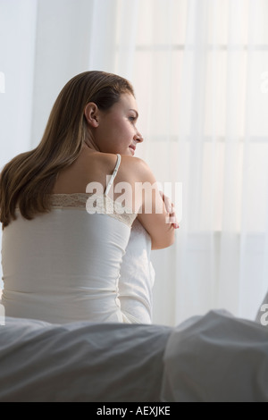 Woman relaxing on her bed Stock Photo