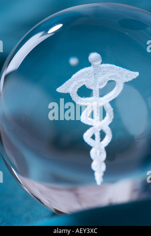 Close up of clear ball with Caduceus symbol in it Stock Photo