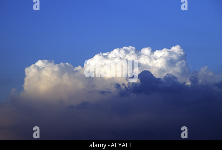 Large dramatic cumulus cloud against blue sky Stock Photo
