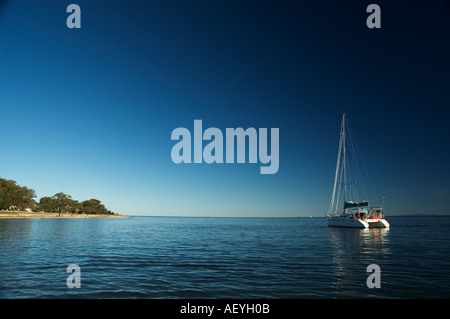 catamaran anchored off Bribie Island Queensland Australia Stock Photo